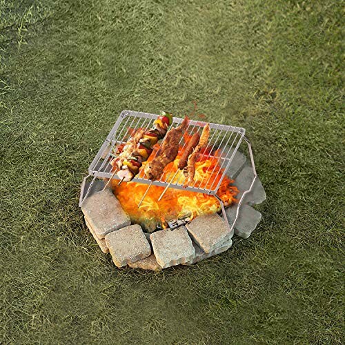 A campfire setup with the grill cooking skewers and meat.