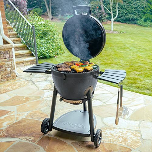 Outdoor charcoal grill with food cooking on a patio