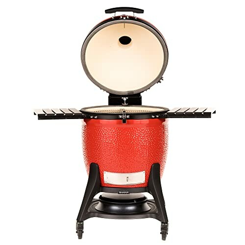 Red ceramic grill with open lid and side shelves